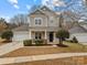 Two-story house with attached garage and landscaping at 7620 Rolling Meadows Ln, Huntersville, NC 28078