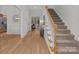 Light-filled foyer with staircase and hardwood floors at 7620 Rolling Meadows Ln, Huntersville, NC 28078