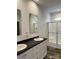 Modern bathroom featuring dual sinks, a sleek countertop, and a glass-enclosed shower at 823 Wellwood Ave, Statesville, NC 28677