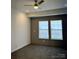 Bedroom with carpeted floor, ceiling fan, and bright, natural light from the windows at 823 Wellwood Ave, Statesville, NC 28677