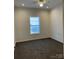 A cozy bedroom featuring neutral paint, carpet, and a window with natural light at 823 Wellwood Ave, Statesville, NC 28677