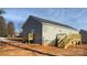 A freshly renovated home exterior features a new wooden deck and stairs, complemented by light gray siding at 823 Wellwood Ave, Statesville, NC 28677