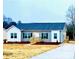 Charming single-story home with gray siding, black shutters, and newly seeded lawn at 823 Wellwood Ave, Statesville, NC 28677