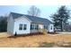 Charming single-story home with a manicured front yard, complemented by gray siding and a welcoming entrance at 823 Wellwood Ave, Statesville, NC 28677