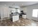 Modern kitchen with white cabinets, stainless steel appliances, a central island, and stylish dark countertops at 823 Wellwood Ave, Statesville, NC 28677