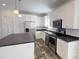 Modern kitchen featuring stainless steel appliances, white cabinets, dark countertops, and wood-look flooring at 823 Wellwood Ave, Statesville, NC 28677