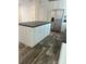 Close up view of a modern kitchen with a dark island countertop, wood-look flooring and stainless steel appliances at 823 Wellwood Ave, Statesville, NC 28677