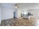 Open concept living room and kitchen featuring wood grain floors, stainless appliances and a ceiling fan at 823 Wellwood Ave, Statesville, NC 28677