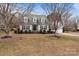 Gray sided two-story house with a two-car garage and mature trees at 841 Deerfield Dr, Mount Holly, NC 28120