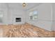 Living room with hardwood floors, fireplace, and built-in shelving at 841 Deerfield Dr, Mount Holly, NC 28120