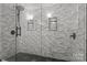 Large shower with marble tile and glass enclosure at 841 Deerfield Dr, Mount Holly, NC 28120