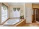 Bathroom with corner soaking tub and walk-in shower at 8622 Lower Rocky River Rd, Concord, NC 28025