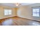 Spacious bedroom with hardwood floors and multiple windows at 8622 Lower Rocky River Rd, Concord, NC 28025