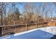 Wooden deck overlooking a wooded backyard with snow at 8622 Lower Rocky River Rd, Concord, NC 28025