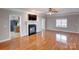 Living room with hardwood floors, fireplace and kitchen view at 8622 Lower Rocky River Rd, Concord, NC 28025