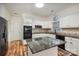 Kitchen with granite island, white cabinets, and hardwood floors at 8804 Ferngrove Ct, Waxhaw, NC 28173