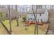 Expansive backyard with a wooden deck, black fence, and mature trees offering privacy at 9230 Windygap Rd, Charlotte, NC 28278