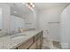 Bathroom featuring a double sink vanity with granite countertop and tiled flooring at 9230 Windygap Rd, Charlotte, NC 28278