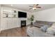 The home's living room featuring a fireplace, built-ins, and a grey sectional sofa at 9230 Windygap Rd, Charlotte, NC 28278