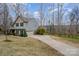 A long driveway leading up to a two-story home and an attached two car garage at 9230 Windygap Rd, Charlotte, NC 28278