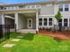 A cozy covered patio leads to the grassy backyard space, fenced and perfect for outdoor relaxation at 10119 Mamillion Dr, Huntersville, NC 28078