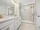 Stylish bathroom features a double sink vanity, tile flooring, and glass-enclosed shower at 10119 Mamillion Dr, Huntersville, NC 28078