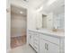 Elegant bathroom features double sinks with white cabinets, granite countertops, and walk-in closet at 10119 Mamillion Dr, Huntersville, NC 28078