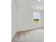 Bright bedroom features a single large window with lush landscape views and soft neutral carpet at 10119 Mamillion Dr, Huntersville, NC 28078