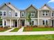 Charming townhomes with varied siding, stone accents, manicured lawns, and inviting sidewalks on a sunny day at 10119 Mamillion Dr, Huntersville, NC 28078