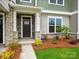 Inviting townhouse front door with stone accents, manicured landscaping, and a welcoming entryway at 10119 Mamillion Dr, Huntersville, NC 28078