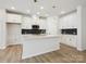Modern kitchen with white cabinets, an island with a quartz countertop, and stainless steel appliances at 10119 Mamillion Dr, Huntersville, NC 28078