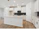 Bright modern kitchen featuring white cabinets, an island, and stainless steel appliances at 10119 Mamillion Dr, Huntersville, NC 28078