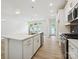 Bright kitchen featuring a large island, stainless steel appliances, and access to the backyard at 10119 Mamillion Dr, Huntersville, NC 28078