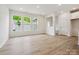 Bright living room featuring wood floors, and multiple windows with views of the yard at 10119 Mamillion Dr, Huntersville, NC 28078