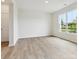 Bright, airy living space with light wood floors and a large window that brings the outside in at 10119 Mamillion Dr, Huntersville, NC 28078