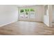 Bright living room featuring wood floors, and multiple windows with views of the yard at 10119 Mamillion Dr, Huntersville, NC 28078