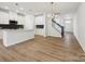 Open concept living and kitchen area featuring a kitchen island, and staircase to the next level at 10119 Mamillion Dr, Huntersville, NC 28078