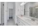 Double vanity bathroom with gray tile floor and glass shower at 1182 Lost Cove Rd, Indian Land, SC 29707