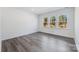 Bright bedroom with gray wood-look flooring and large windows at 1182 Lost Cove Rd, Indian Land, SC 29707