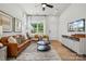 Living room with leather couch, coffee table, and large TV at 1182 Lost Cove Rd, Indian Land, SC 29707