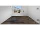 Bright living room with gray wood-look flooring and large window at 1182 Lost Cove Rd, Indian Land, SC 29707