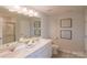 Modern bathroom with double vanity and a large mirror at 12028 Grinstead Ln # 292, Charlotte, NC 28278