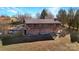 Aerial view of a two-story home with a large deck and surrounding land at 1262 Ring Tail Rd, Claremont, NC 28610