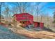 Exterior view of a red barn with horse stalls and a loft at 1262 Ring Tail Rd, Claremont, NC 28610