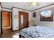 Bright bedroom with a blue and white quilt and wood flooring at 1262 Ring Tail Rd, Claremont, NC 28610