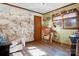 Charming bedroom featuring unique wallpaper, hardwood floors, and a bright window at 1262 Ring Tail Rd, Claremont, NC 28610