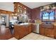 Kitchen with island, wood cabinets, stainless steel dishwasher, and view to dining area at 1262 Ring Tail Rd, Claremont, NC 28610