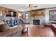 Living room features a stone fireplace, hardwood floors, and a large flat-screen TV at 1262 Ring Tail Rd, Claremont, NC 28610