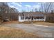 House with driveway and yard, wooded area behind at 127 Halifax Ct, Gastonia, NC 28056