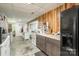 Small basement kitchen with full-size refrigerator and island at 127 Halifax Ct, Gastonia, NC 28056